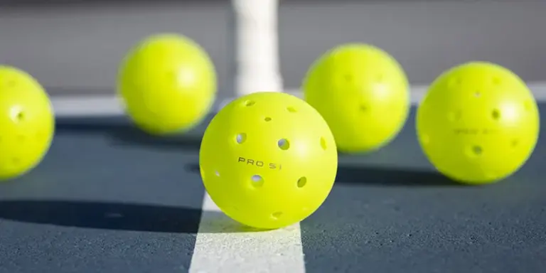 Selkirk neon yellow pickeballs on court