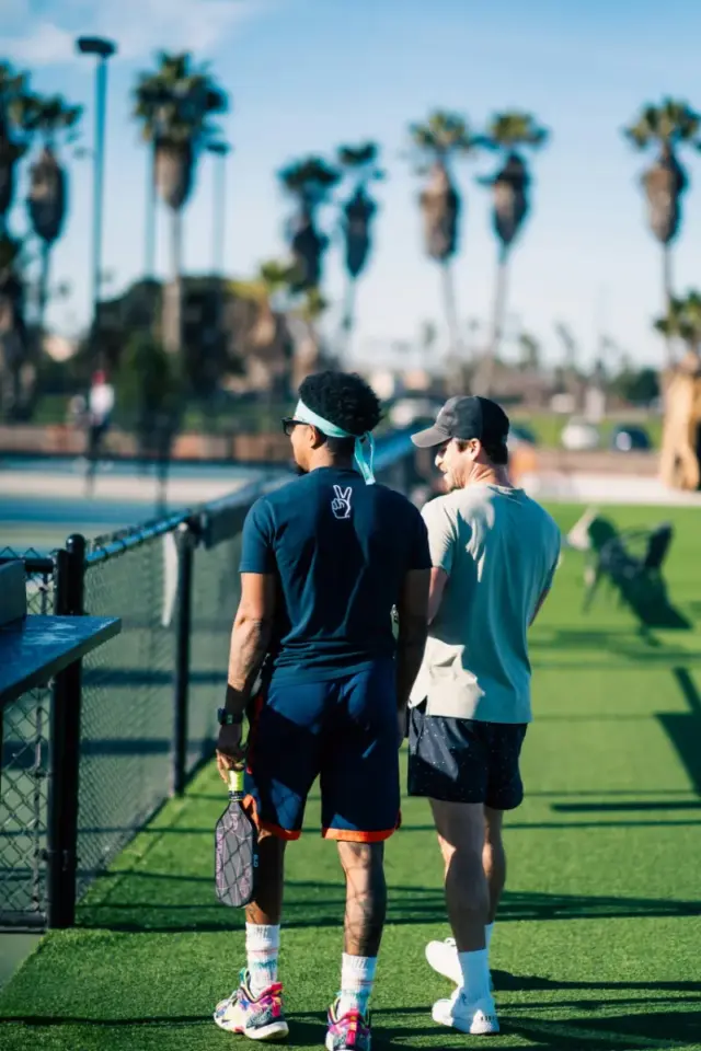 two pickleball players looking at pickleball courts ready to play